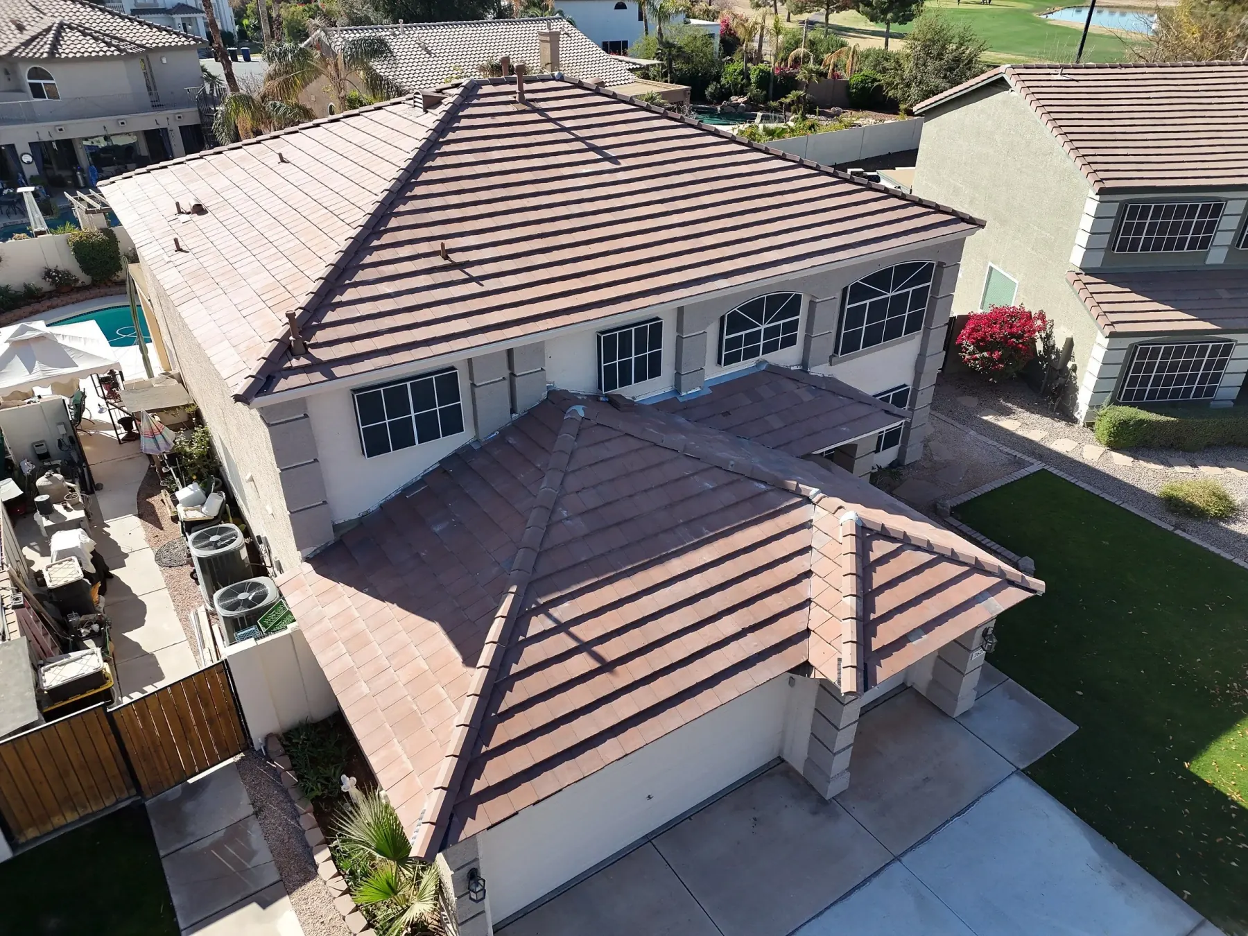 Oblique aerial view of pale terracotta tile roofs with dark exposed ridge and hip strips